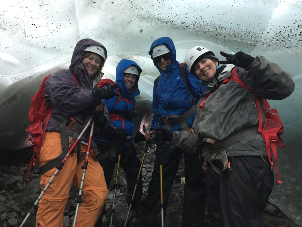 4 females standing in an ice cave