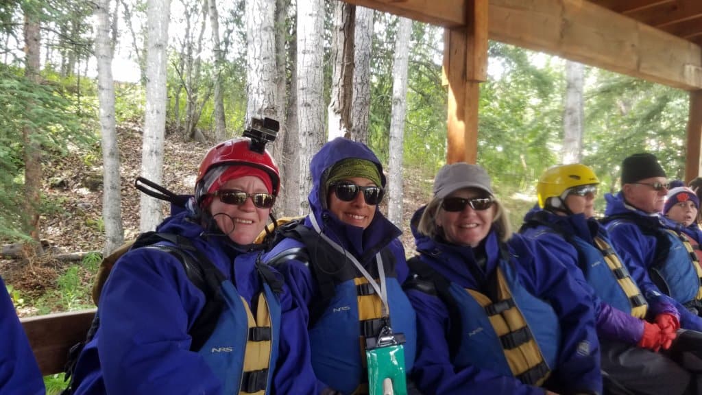 3 female friends with blue splash suits sitting on a bench