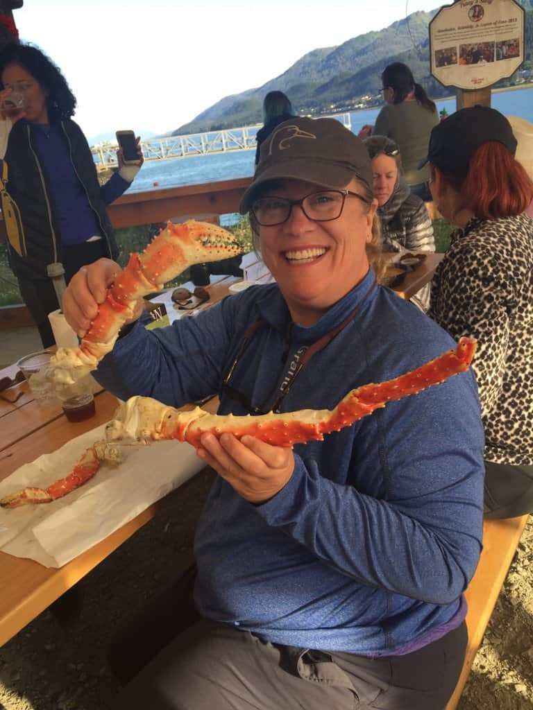 female holding king crab legs