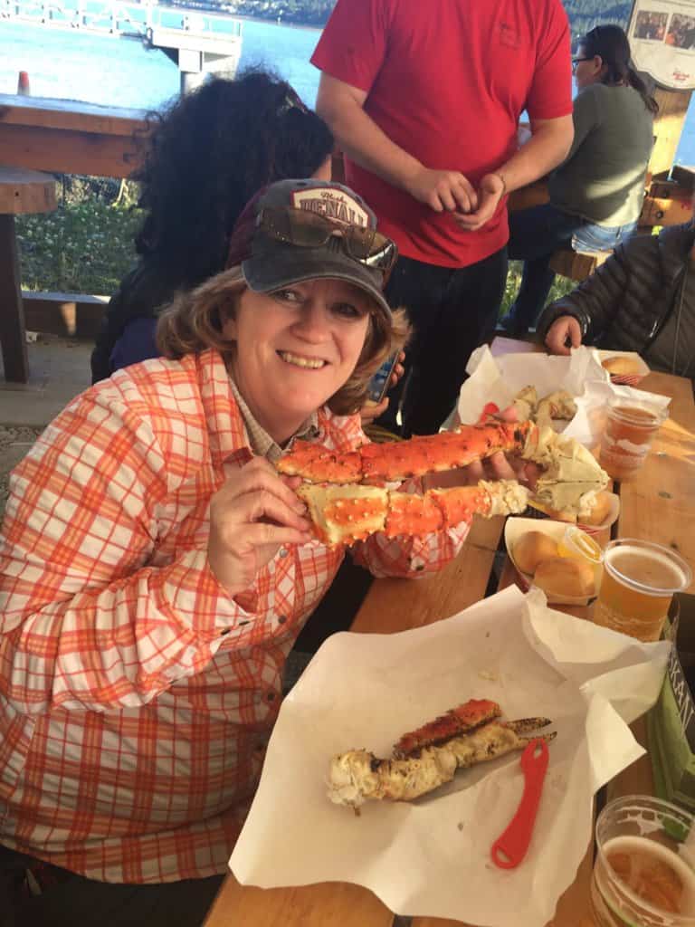 female holding king crab legs