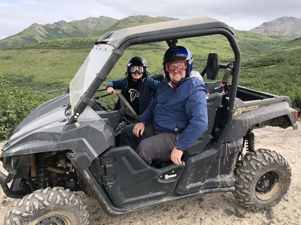 Father and son sitting in an ATV