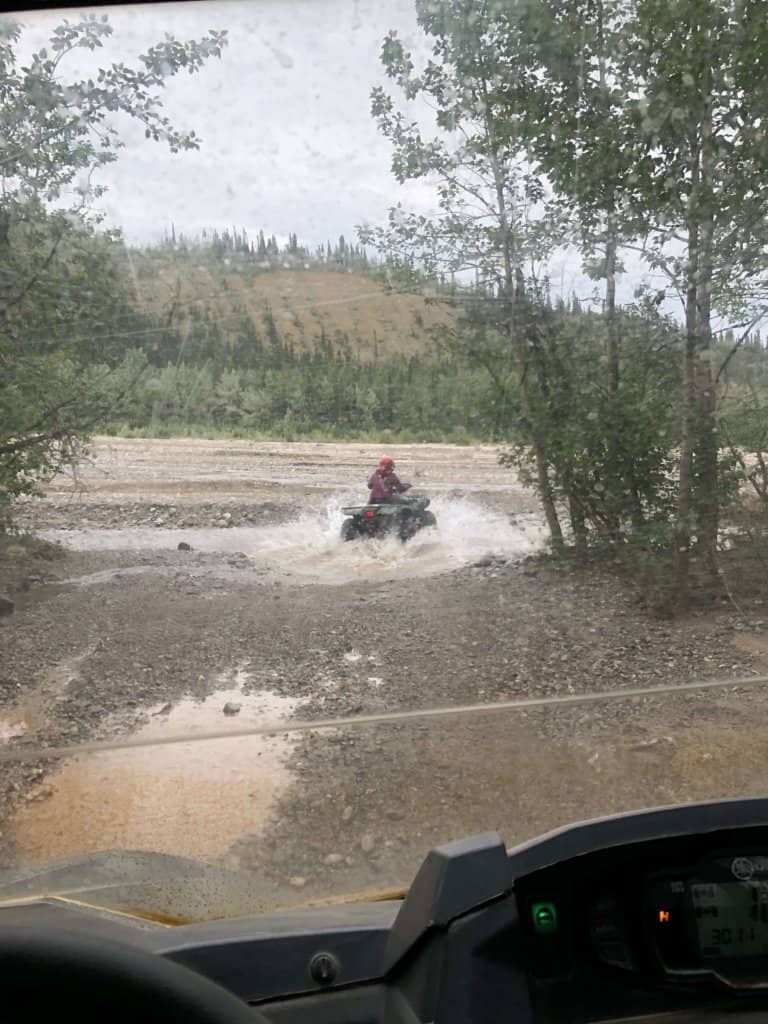 ATV riding through a big puddle of water