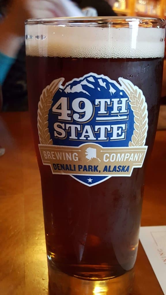 Glass of beer in a glass reading 49th State