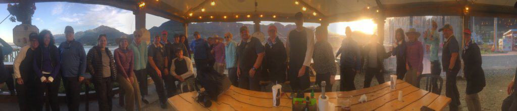 panoramic of friends standing inside a tent