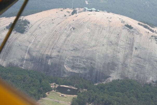 carving in a stone mountain of 3 generals on horses from the air