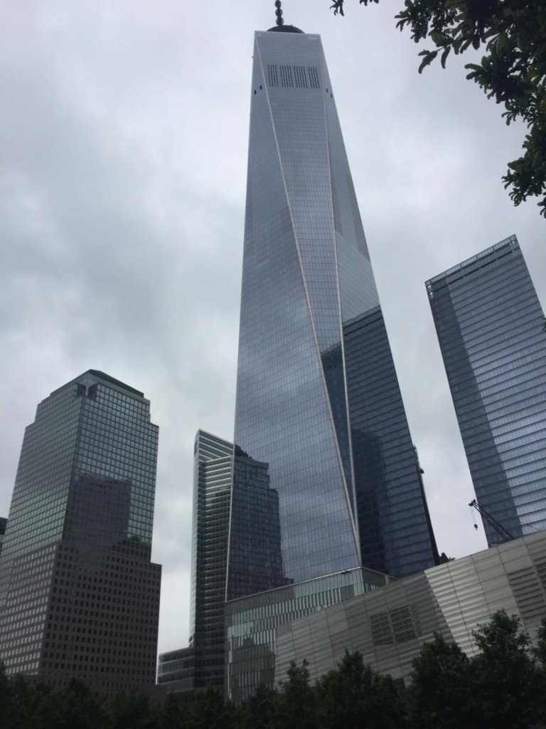 one very tall building with 2 smaller ones on each side