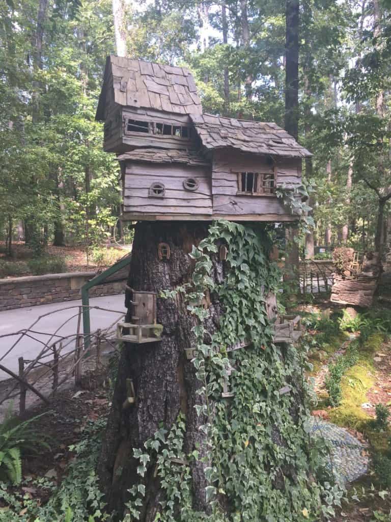 a dwarf treehouse alongside a path