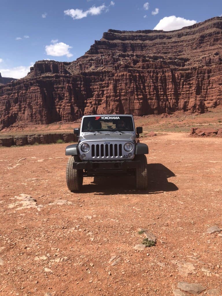 front of a Jeep in the desert