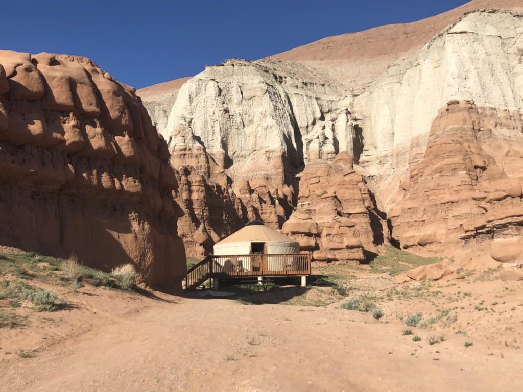 a yurt set against red rocks