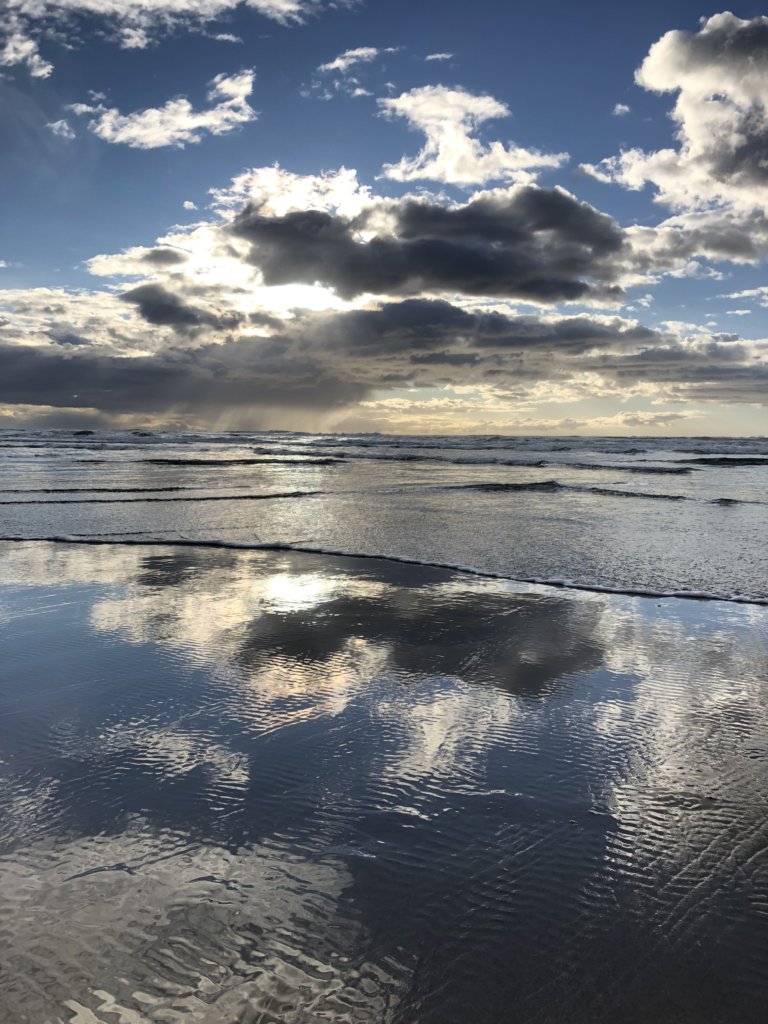 ocean with blue skies and clouds at sunset