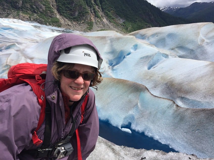 Hike on a glacier above blue crevasse